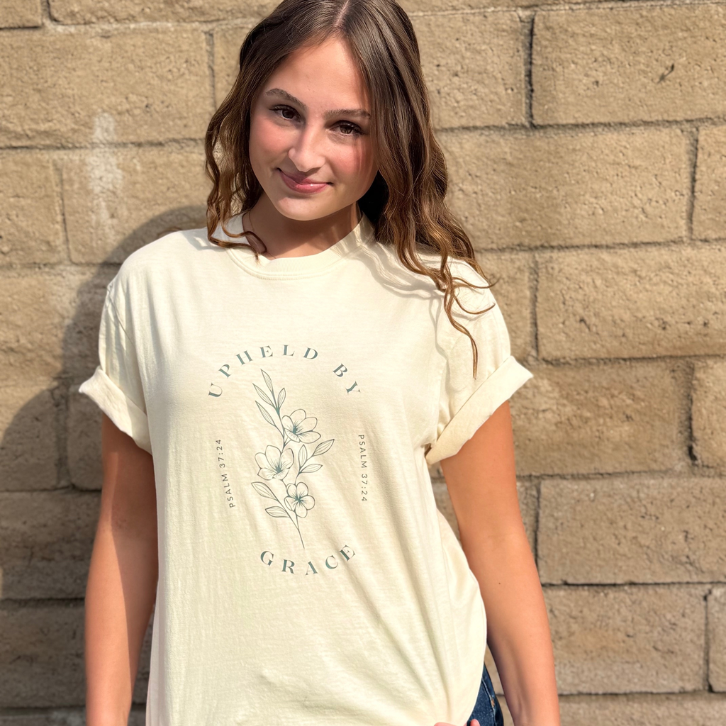 UPHELD BY GRACE TEE