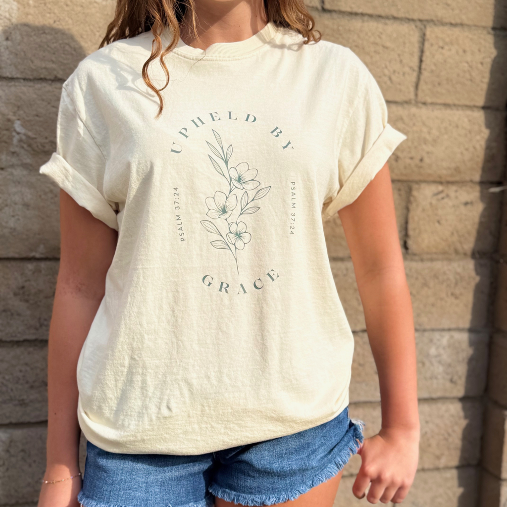UPHELD BY GRACE TEE