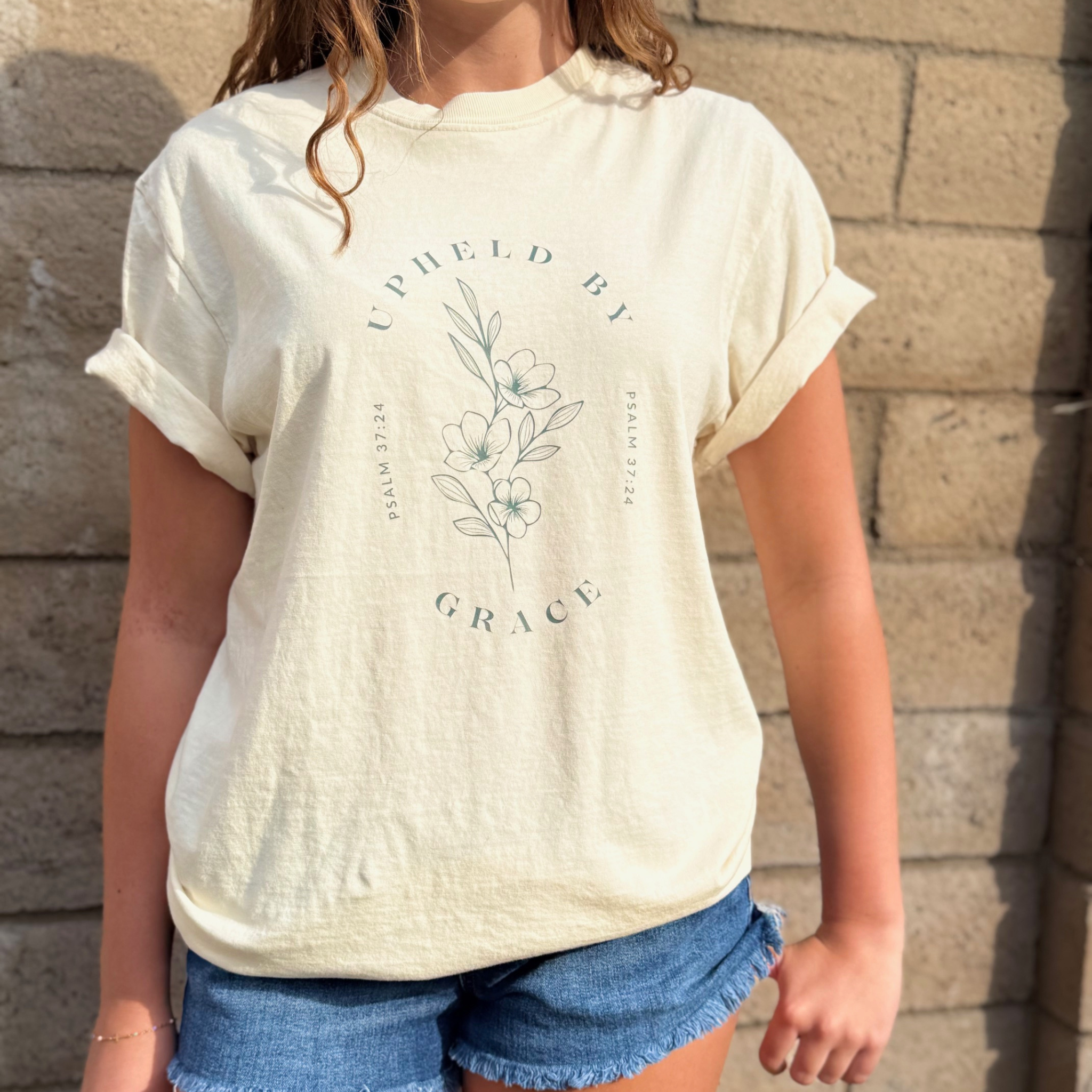 UPHELD BY GRACE TEE